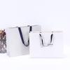 Suministro directo de fábrica bolsa tote de cartón blanco al por mayor bolsa de papel para tienda de ropa bolsa kraft logo impreso bolsa de papel tote engrosada