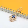 Chaveiro Mão de Fátima Olhos Azuis Full Diamond Pingente de Chaveiro Olho do Diabo Metálico Vazado