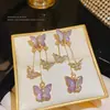 Pendientes de borla larga con mariposa morada de temperamento súper de hada, pendientes de botón de lujo ligero, nicho, mismo estilo que las celebridades de internet, pendientes de acero inoxidable