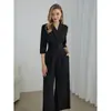 Moda europea y americana transfronteriza para mujer 2025 primavera y otoño elegante color liso cuello en V manga corta pierna ancha mono
