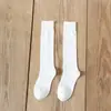 Fornecimento direto da fábrica outono e inverno jk meias de cano alto cor sólida japonesa meias longas cor sólida moda meias de joelho femininas JK meias femininas