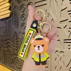 Llaveros de dibujos animados transfronterizos de policía, bombero, policía de tráfico y oso, inodoros y lindos, colgantes para coche y bolso, regalos de figuras