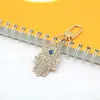 Llavero de Mano de Fátima con Ojos Azules y Diamantes Completos Llavero Colgante de Ojo del Diablo Hueco de Metal