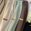 Pantalones elásticos frescos de seda de hielo contra-retirada orden de cola fuga-recogida productos genuinos marca grande comercio exterior etiqueta cortada estilo Hong Kong retro rectos