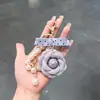 Colgante de Tela Camelia Estilo Suave Estilo Coreano con Puntos Pequeños, Lazo y Cadena de Perlas Llavero Accesorio para Bolso