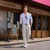 Pantalones de trabajo rectos de moda y versátiles con múltiples bolsillos para hombre, adecuados para primavera y otoño, con cintura ajustable con cordón, disponibles en stock