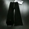 Pantalones de chándal de cuadros patchwork deconstruidos negros para hombre, marca de tendencia de otoño, pantalones rectos de alta gama que estilizan, pantalones de microcampana estilo americano