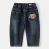 Ropa Infantil para Niños 2026 Primavera y Otoño Nuevos Jeans Infantiles para Niños Mayores y Niños Pequeños, Pantalones de Mezclilla de Color Sólido con Dibujos