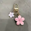 Pingente de chaveiro de flor de metal transfronteiriço, decoração de flor simples e feminina para celular, acessório de pingente para bolsa