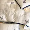 Juego de Cuatro Piezas de Verano 60S de Tencel Sedoso Clase A en Blanco Crema con Mariposas Revoloteando, Funda Nórdica Refrescante y Sábana Bajera de Lyocell Texturizado