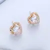 Un conjunto de pendientes collar anillo de corazón de melocotón chapados en oro con circonita microincrustada de material de cobre conjunto de cuatro piezas de joyería de comercio europeo y americano