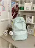 Mochila pequeña, simple, de color sólido con bordado de letras texturizado, diseñada para estudiantes mujeres, adecuada para la escuela y el uso diario, ligera y reduce la carga en los hombros