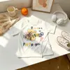 Novo Modelo de Comércio Exterior 2026 Estilo Coreano Verão Novo Conjunto de Duas Peças para Meninas com Estampa de Urso, Top de Manga Curta Dividido e Saia Plissada Xadrez
