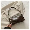 Bolso de charol brillante para debajo del brazo para mujer, nuevo modelo 2026, bolso de un solo hombro cruzado, simple y elegante, bolso de mano versátil de nicho para mujer