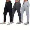 Marca independiente, comercio electrónico transfronterizo, pantalones deportivos versátiles para hombre con cordón, bolsillos y cremallera, duraderos y de corte ajustado, disponibles para venta al por mayor