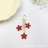 Llavero con forma de flor de gota de aceite de color transfronterizo de Europa y Estados Unidos, personalidad creativa, lindo bolso colgante con juego de auriculares