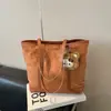 Bolsa de Mão Grande de Textura para Estudantes e Commuters Femininos 2025 Outono e Inverno Nova Bolsa Tote de Ombro Casual Estilosa de Nicho