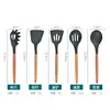 Venta al por mayor de fábrica Amazon Juego de utensilios de cocina de silicona con mango de madera Juego de 11 piezas Utensilios de cocina Olla para cocinar Pala Cuchara