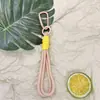 Llavero con tema de dopamina con cordón trenzado, diseño colorido y minimalista, adecuado para teléfonos y llaves de coche, un accesorio elegante con un toque de lujo