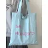 Bolsa de Lona com Estampa de Letras Nova Primavera Grande Capacidade Bolsa de Ombro Feminina Simples Fresca Versátil
