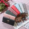 Cartera larga para mujer, nueva, directa de fábrica, con 30% de descuento, de metal, estilo Joker, estilo japonés y coreano, bolso de mano con múltiples tarjetas