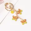 Llavero de Mariposa con Goteo de Aceite Versátil de Moda Llavero de Mariposa con Flor Colgante para Bolso de Mujer Regalos Pequeños Exquisitos Venta al por Mayor