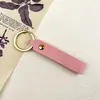 Llave de metal de cuero artificial PU doble cara de cuero -2 cuero pequeño llavero de regalo anillo de metal colgante simple 6g