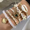 Pulsera trenzada con cuentas de concha estilo bohemio nuevo transfronterizo, estilo playa, juego de siete piezas de cuentas de arroz y estrellas de mar