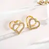 Pendiente de acero inoxidable para mujer con diseño geométrico hueco de doble corazón de melocotón e incrustaciones de circonita, tipo clip, flor de ciruelo, joyería simple y versátil