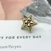 Suministro directo botón metálico de estrella de cinco puntas retro botón pequeño fragancia estilo europeo y americano suéter abrigo abrigo de cuero accesorios de joyería