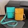 Bolsa Pequeña de Tela de Nylon Simple de Nicho de Verano para Mujer 2025 Nueva Moda Casual Bolso Cruzado Bolso para Teléfono Móvil