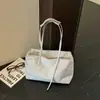 Bolsos de nicho estilo coreano transfronterizos 2026 Otoño Nuevo estilo Moda Versátil Casual para el trabajo Gran capacidad Bolso de hombro único para llevar bajo el brazo