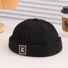 Ins primavera y otoño nuevo estilo coreano para niños bebé todo partido letras moda otoño e invierno cálido gorro de piso moderno gorro de cuero melón