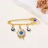 Broche de Borla Ojo del Diablo Creativo Europeo y Americano Incrustado con Diamantes, Pin de Estilo Frío para Suéter de Cintura Ojos Azules de Alta Gama