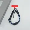 Estilo ins correa de teléfono tejida de color contrastante correa corta para la muñeca colgante de llavero de cámara CCD anti-pérdida unisex