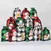 Bolsa de algodón con cordón de Navidad al por mayor bolsa de almacenamiento de dulces y regalos Bolsa de algodón con diseño de pingüino a cuadros navideños personalización