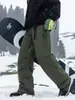 Pantalones de trabajo acolchados a prueba de frío de la marca de moda Izexx, con logo personalizado, para hombres y mujeres, pantalones térmicos de invierno para exteriores