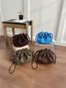 Bolso tipo cubo con flecos estilo coreano para mujer, nueva colección otoño/invierno 2026, acabado mate, bolso de hombro, bolso cruzado, diseño de alta gama, bolso de cordón de nicho