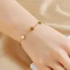 Europa y Estados Unidos moda transfronteriza todo a juego alta calidad superficie fotosensible acero inoxidable chapado en oro flor de margarita pendientes de botón pulsera collar traje