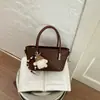 Bolso de mano de moda con patrón tejido de nicho de color sólido 2026 nuevo para principios de otoño bolso cruzado bolso de hombro simple y elegante