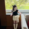 Conjunto para Niña 2026 Verano Nuevo Infantil Súper Lindo Dulce Estilo Hepburn Camiseta de Manga Abullonada Falda Corta con Lazo