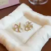 Pendientes de botón de flor con goteo de aceite estilo francés Aguja de plata Estilo Ins Coreano Pendientes Sencillos Lujo Ligero Sensación de Alta Gama Pendiente Venta al por Mayor