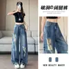 Jeans rasgados estilo retro americano talla grande para mujer, nuevo estilo principios de otoño 2026, diseño de calle moderno, pantalones de tiro bajo hasta el suelo