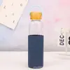 Botella de vidrio de una sola capa nueva transfronteriza gran capacidad tapa de bambú taza de burbujas anti-quemaduras aislamiento térmico asa portátil taza acompañante para exteriores