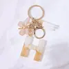 Llavero Colgante de Borla con Letra Inglesa Personalizada de Purpurina Blanca con Resina Epoxi y Colgante de Resina con Pan de Oro, Llavero Sencillo