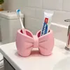 Portacepillos de dientes con forma de lazo, organizador de escritorio para cepillo de dientes eléctrico y pasta de dientes, estante de almacenamiento para tocador de baño, artículo decorativo