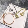 Pulsera de Borde de Perlas de Diamante Incrustado con Doble Flor de Venta Caliente Transfronteriza Europea y Americana Trébol Flor de Seis Pétalos Apertura Pulsera de Nicho Pulsera