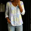 Nueva camisa estampada de cuello V abotonada de manga larga transfronteriza para mujer, elegante y con estilo para ir al trabajo, top casual único y moderno