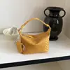 Bolso de hombro y bandolera versátil, simple y elegante, de nicho, para mujer, verano 2026, nuevo diseño tejido de albóndiga
