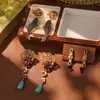 Estilo de corte europeo y americano oro ruso nicho nuevos aretes medievales borla perla diseño ojo de tigre aretes de alta gama